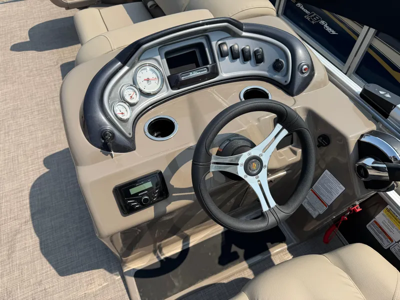 Slide: The Image of 2023 Sun Tracker Fishin' Barge 20 DLX dashboard with steering wheel and gauges. - 11
