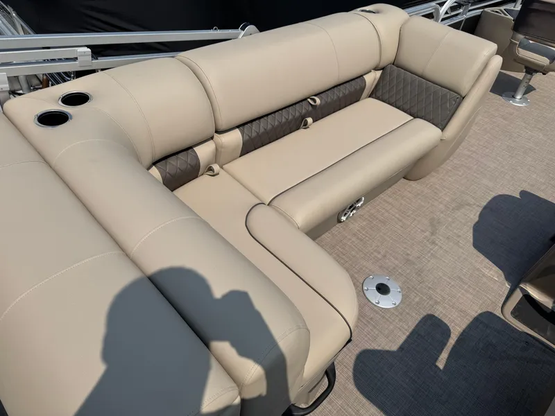 Slide: The Image of 2023 Sun Tracker Fishin' Barge 20 DLX, beige seating with cup holders, on a boat deck. - 16