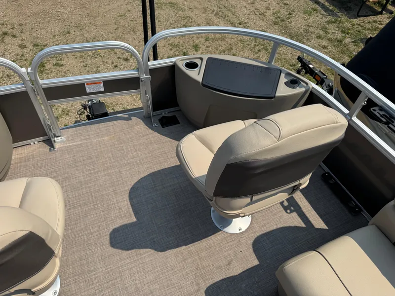Slide: The Image of 2023 Sun Tracker Fishin' Barge 20 DLX interior with beige seating and railing. - 7