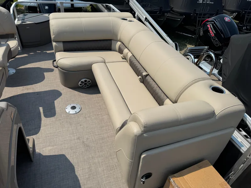 Slide: The Image of 2023 Sun Tracker Fishin' Barge 20 DLX with beige seating and spacious deck layout. - 9