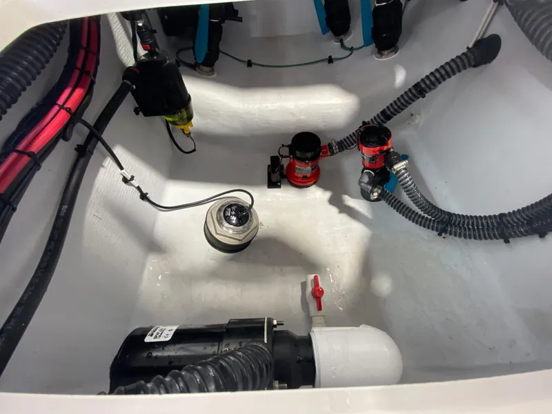 Slide: The Image of Bilge area of 2026 Reef Runner 230 boat with pumps and wiring. - 13
