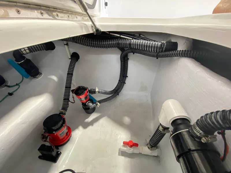 Slide: The Image of Bilge area of 2026 Reef Runner 230 boat with pumps and hoses. - 14