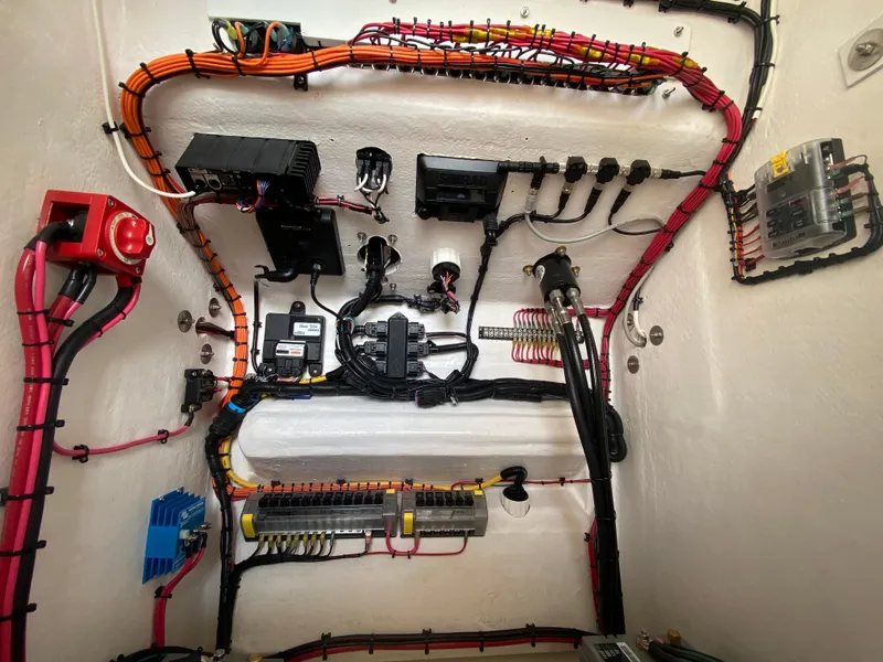 Slide: The Image of Electrical wiring system inside 2026 Reef Runner 230 boat, showcasing organized cables and components. - 19