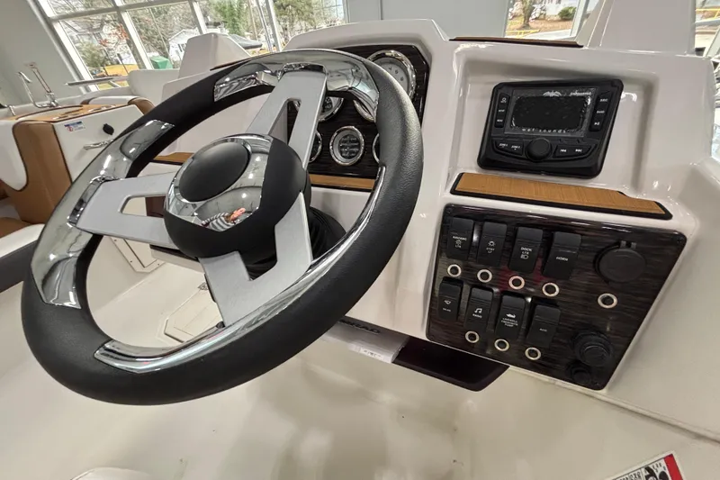 Slide: The Image of 2025 Starcraft SVX 191 OB steering console with controls. - 15