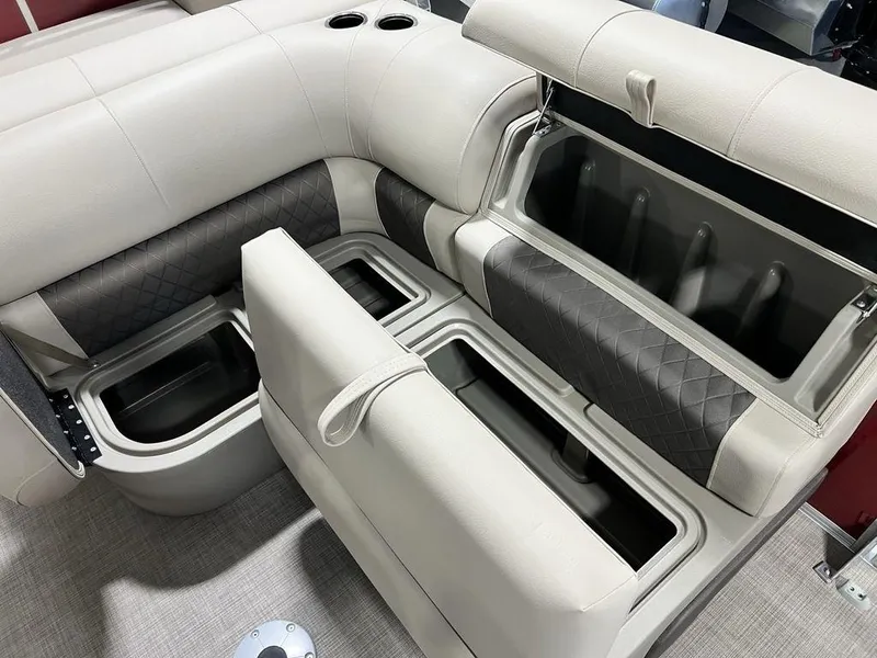 Slide: The Image of 2025 Sun Tracker PARTY BARGE® 22 RF DLX seating with built-in storage compartments and cup holders. - 11