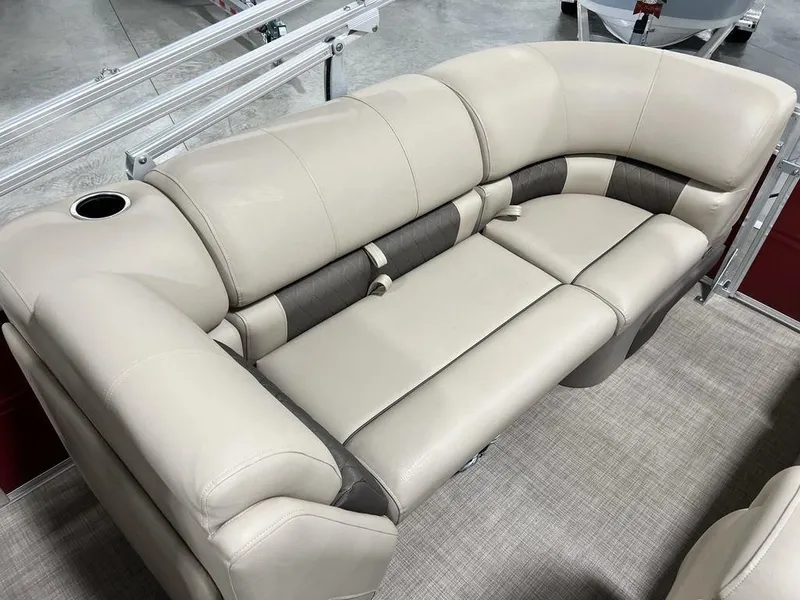 Slide: The Image of 2025 Sun Tracker PARTY BARGE® 22 RF DLX beige and brown cushioned seating with cup holder. - 17