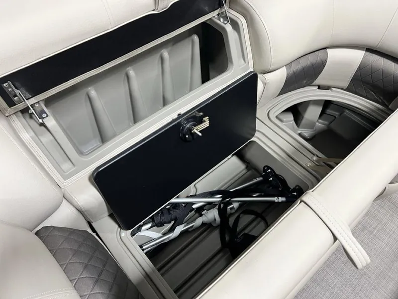 Slide: The Image of Storage compartment in 2025 Sun Tracker PARTY BARGE® 22 RF DLX with open lid and visible contents. - 18
