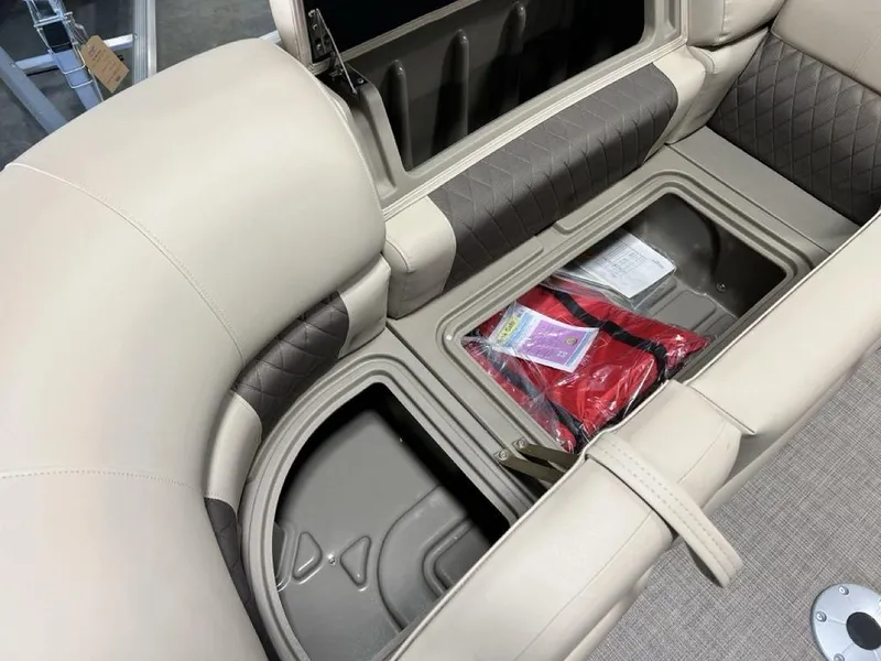 Slide: The Image of 2025 Sun Tracker PARTY BARGE® 22 RF DLX interior storage with life jacket and seating. - 6