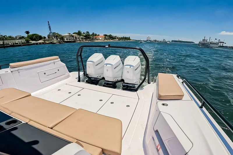 Slide: The Image of 2026 Axopar 45 Cross Top boat with triple Mercury engines on a sunny day. - 12