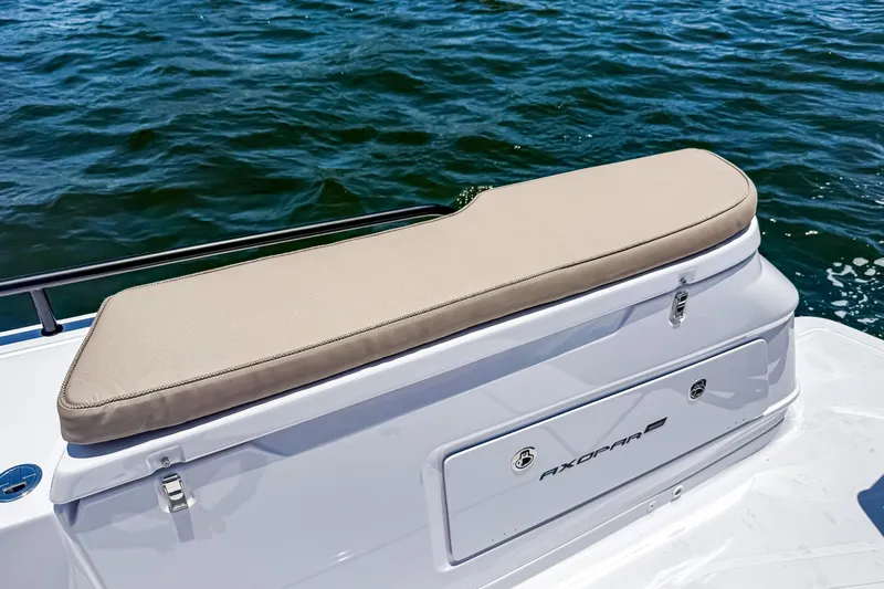 Slide: The Image of 2026 Axopar 45 Cross Top boat with cushioned seating, on calm water. - 14