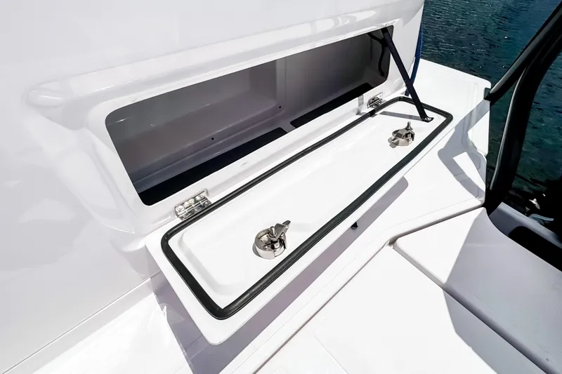 Slide: The Image of Axopar 45 Cross Top 2026, open storage compartment on boat. - 16