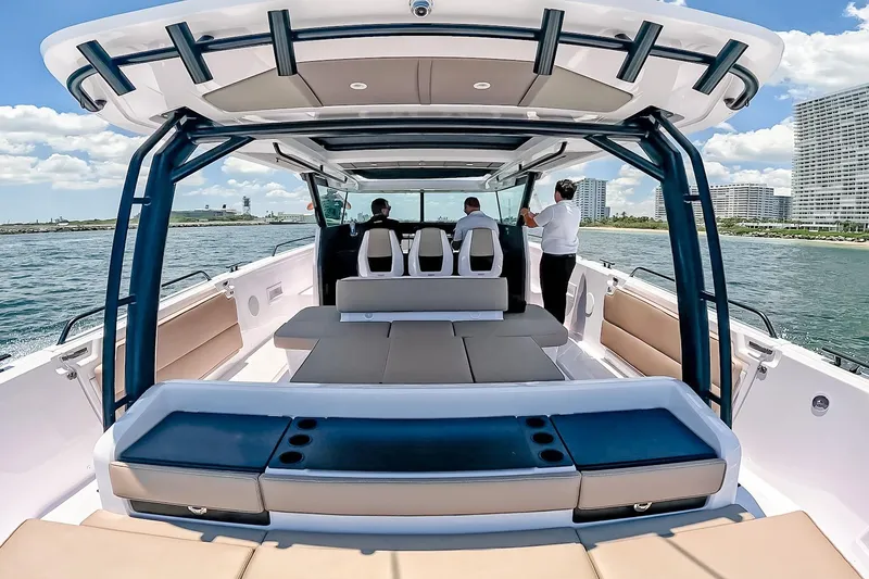 Slide: The Image of 2026 Axopar 45 Cross Top boat with spacious seating, cruising on open water. - 20