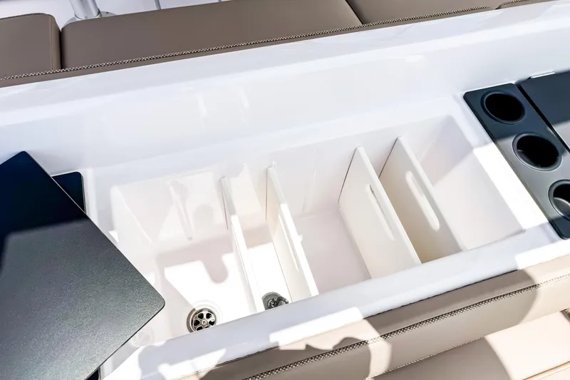 Slide: The Image of Axopar 45 Cross Top 2026, interior with cup holders and storage. - 22