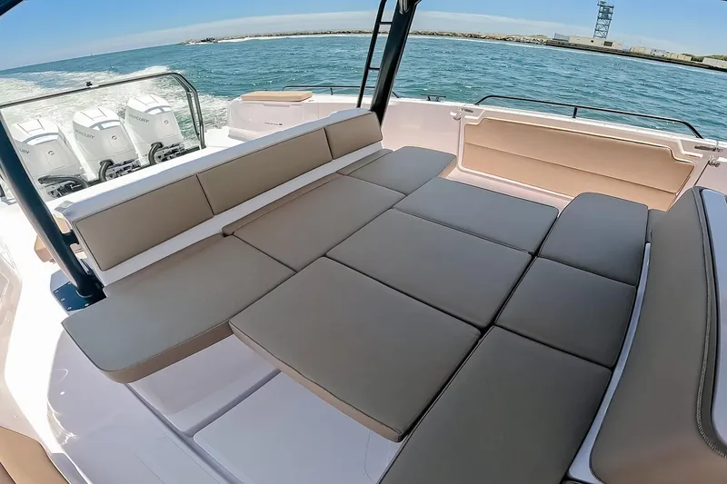 Slide: The Image of Luxurious seating area on 2026 Axopar 45 Cross Top boat with scenic ocean view. - 24