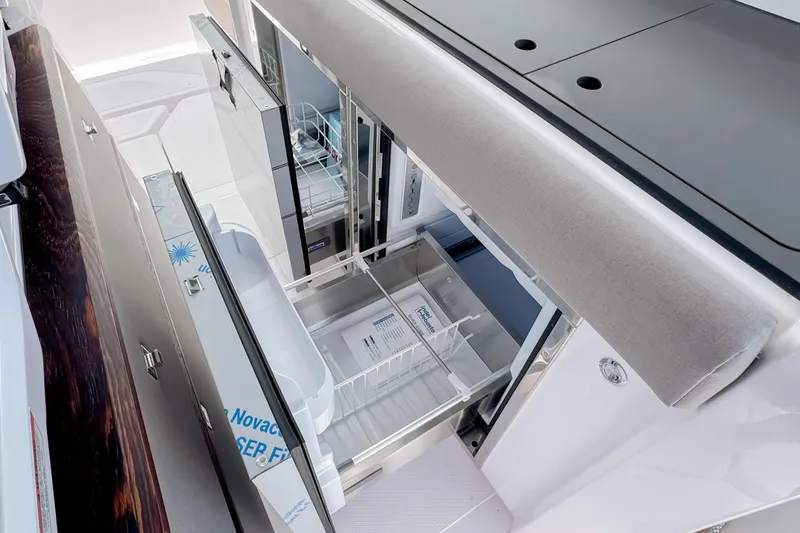 Slide: The Image of Interior of Axopar 45 Cross Top 2026 featuring refrigerator. - 30