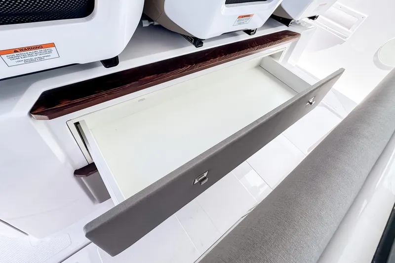 Slide: The Image of Axopar 45 Cross Top 2026, open interior drawer. - 32
