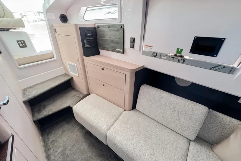 Slide: The Image of Interior of 2026 Axopar 45 Cross Top with sofa and storage. - 39