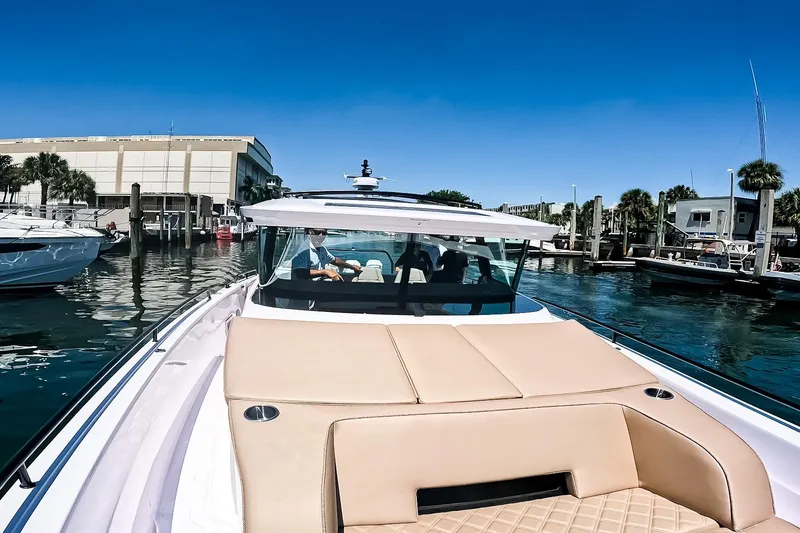 Slide: The Image of 2026 Axopar 45 Cross Top boat docked in a sunny marina setting. - 46