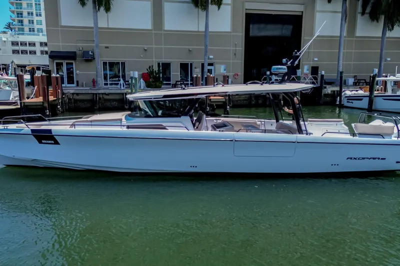 Slide: The Image of 2026 Axopar 45 Cross Top boat docked in marina, sleek design, modern features. - 50