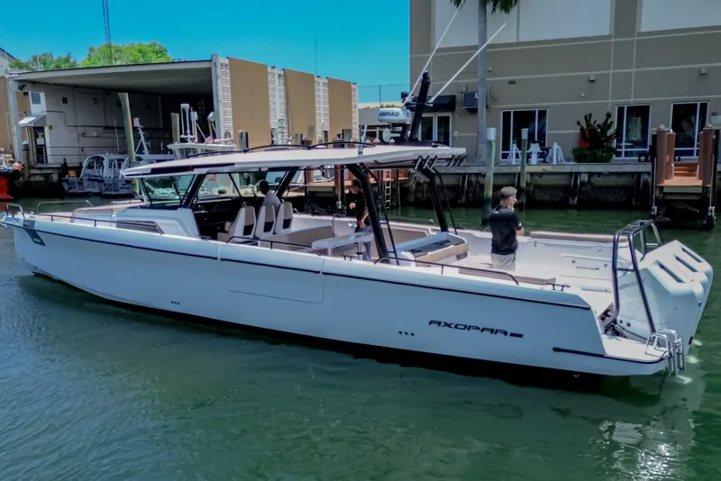 Slide: The Image of 2026 Axopar 45 Cross Top boat docked in marina, featuring sleek design and modern amenities. - 51
