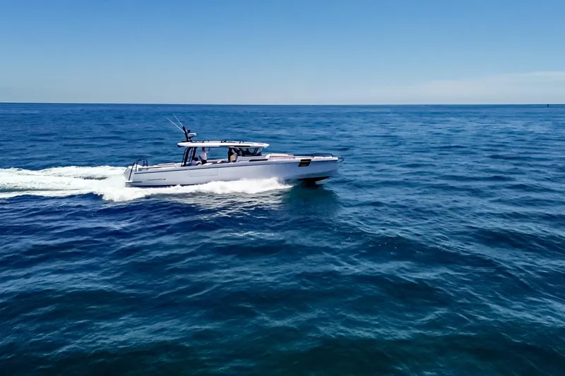 Slide: The Image of 2026 Axopar 45 Cross Top cruising on open blue sea. - 53