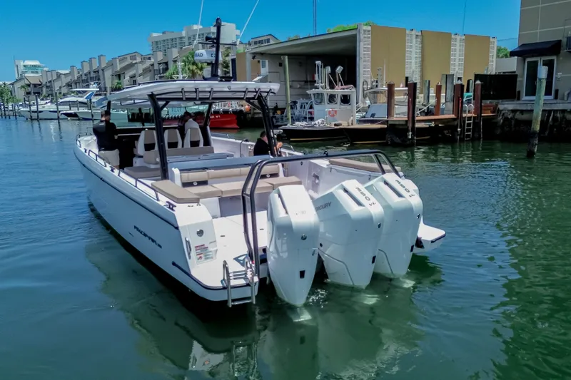 Slide: The Image of 2026 Axopar 45 Cross Top boat with triple engines docked in marina. - 6