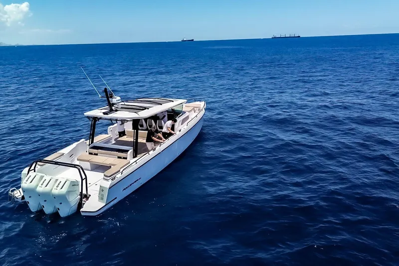 Slide: The Image of 2026 Axopar 45 Cross Top boat cruising on open blue sea. - 7
