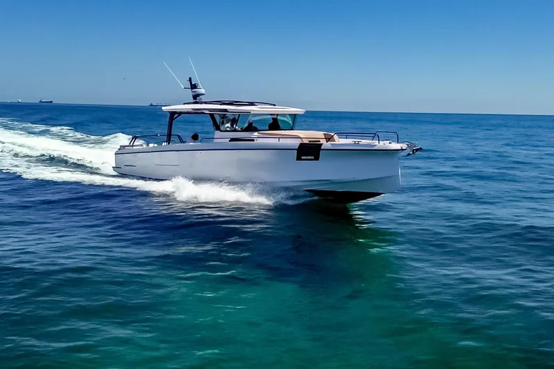 Slide: The Image of 2026 Axopar 45 Cross Top cruising on clear blue ocean waters. - 8