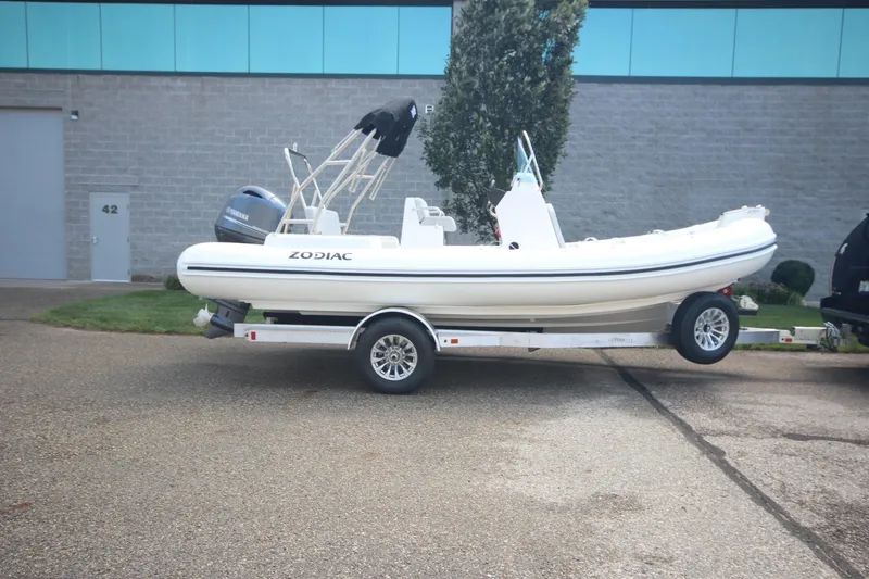 The Image of 2025 Zodiac Medline 5.8 NEO boat on trailer, parked outdoors. - 1
