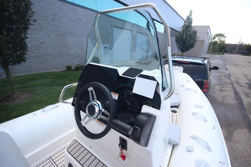Slide: The Image of 2025 Zodiac Medline 5.8 NEO boat with 115hp engine, sleek design, and modern controls. - 13