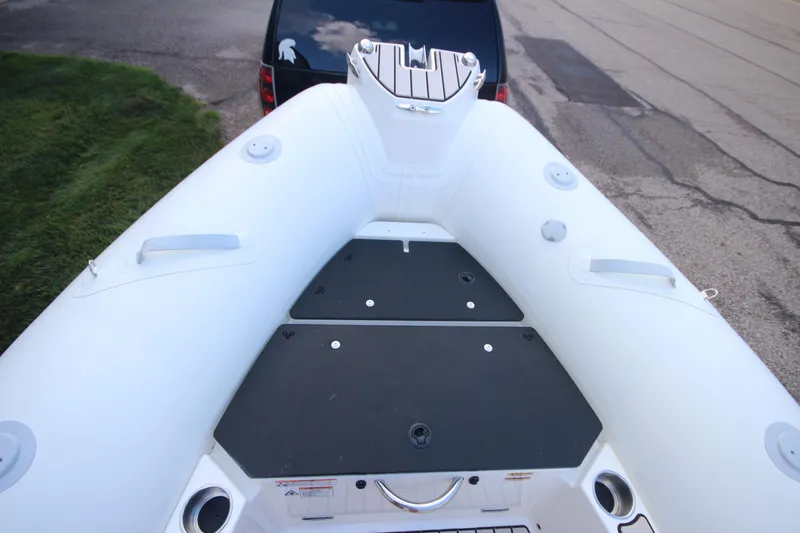 Slide: The Image of 2025 Zodiac Medline 5.8 NEO boat, top view, showing deck and seating area. - 16