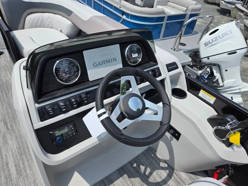 Slide: The Image of Steering console of 2026 Godfrey Sweetwater 2286 QS with Garmin display and Suzuki engine. - 13