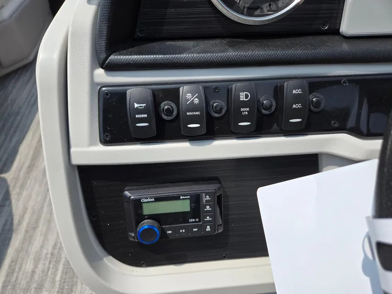 Slide: The Image of Control panel of 2026 Godfrey Sweetwater 2286 QS boat with switches and Clarion audio system. - 15