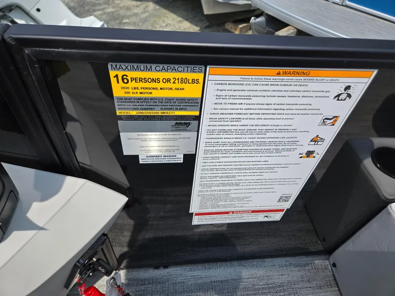 Slide: The Image of Capacity warning label on 2026 Godfrey Sweetwater 2286 QS boat, max 16 persons or 2180 lbs. - 18