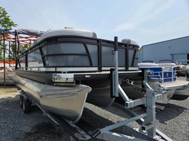 Slide: The Image of 2026 Godfrey Sweetwater 2286 QS pontoon boat on trailer, parked outdoors. - 2