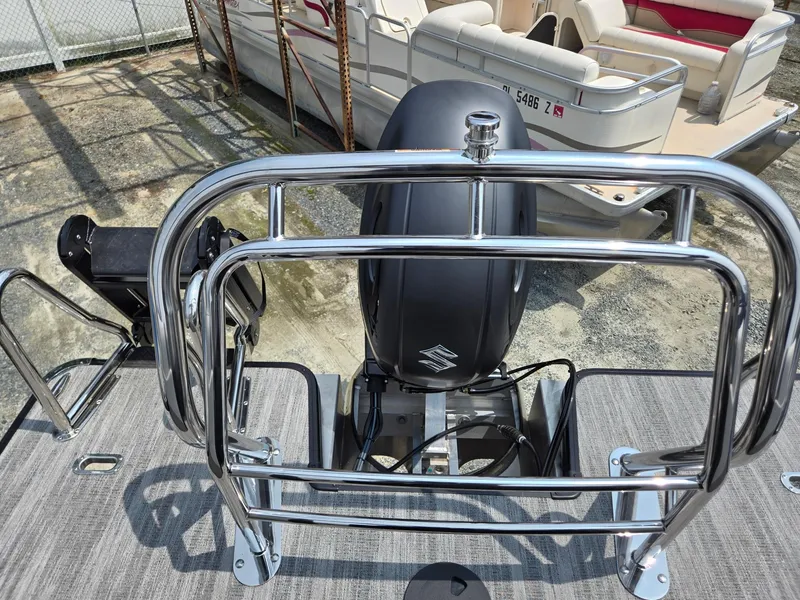 Slide: The Image of 2026 Godfrey Sweetwater 2286 QS boat with Suzuki outboard motor and chrome railing. - 25