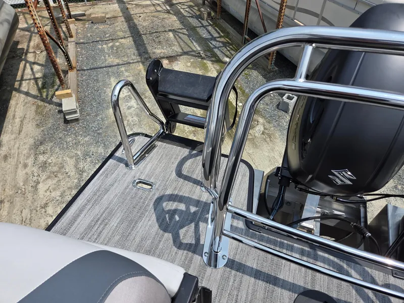 Slide: The Image of 2026 Godfrey Sweetwater 2286 QS boat deck with chrome railings and outboard motor. - 26