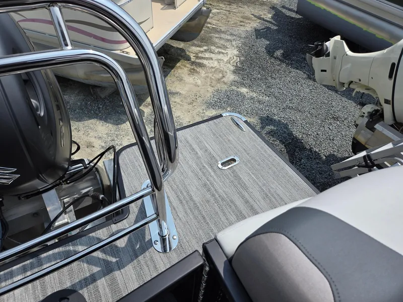 Slide: The Image of 2026 Godfrey Sweetwater 2286 QS boat deck with chrome railing and motor. - 27