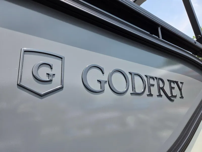 Slide: The Image of 2026 Godfrey Sweetwater 2286 QS boat logo on gray surface. - 38