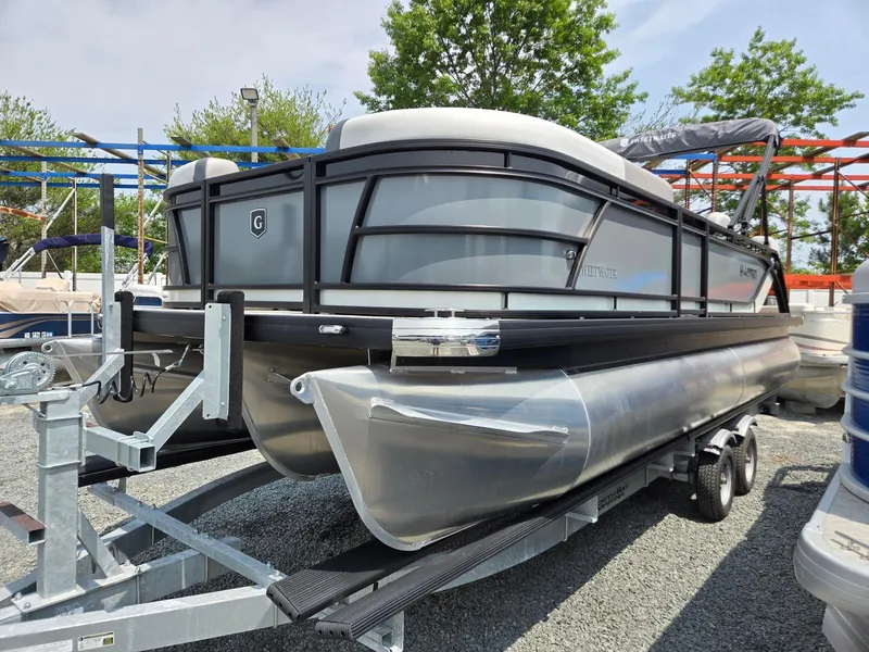Slide: The Image of 2026 Godfrey Sweetwater 2286 QS pontoon boat on trailer, parked outdoors. - 4