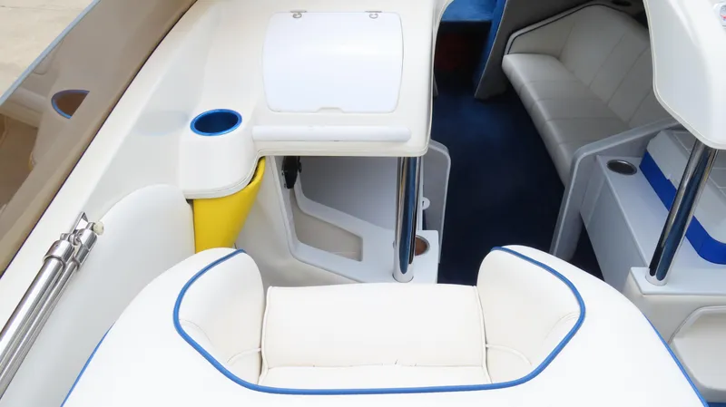 Slide: The Image of Interior of a 2002 Nordic 28 Heat boat with white seating and blue accents. - 12