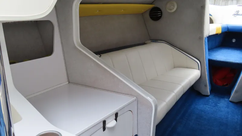 Slide: The Image of Interior of a 2002 Nordic 28 Heat boat with white seating and blue carpet. - 8