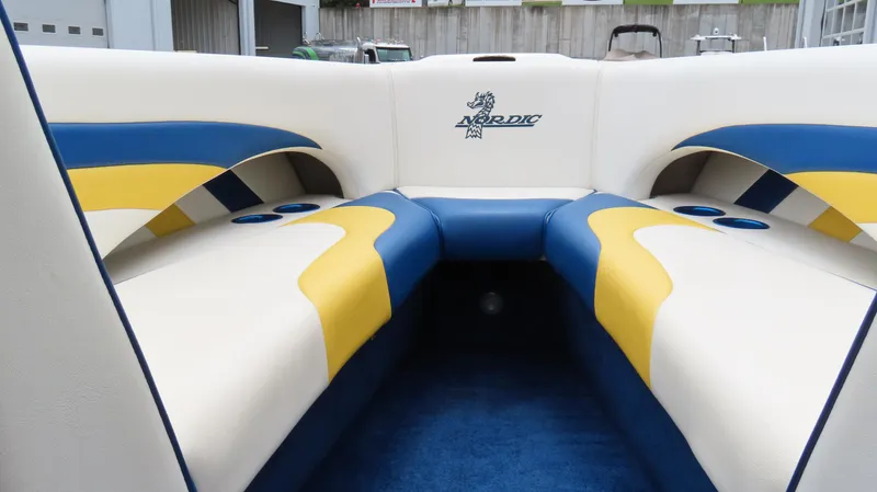 Slide: The Image of Interior of 2002 Nordic 28 Heat boat with blue and yellow seating. - 9