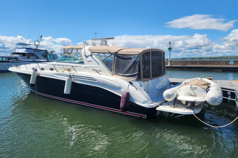 Slide: The Image of 1997 Sea Ray 450 yacht docked in a marina under a clear blue sky. - 1