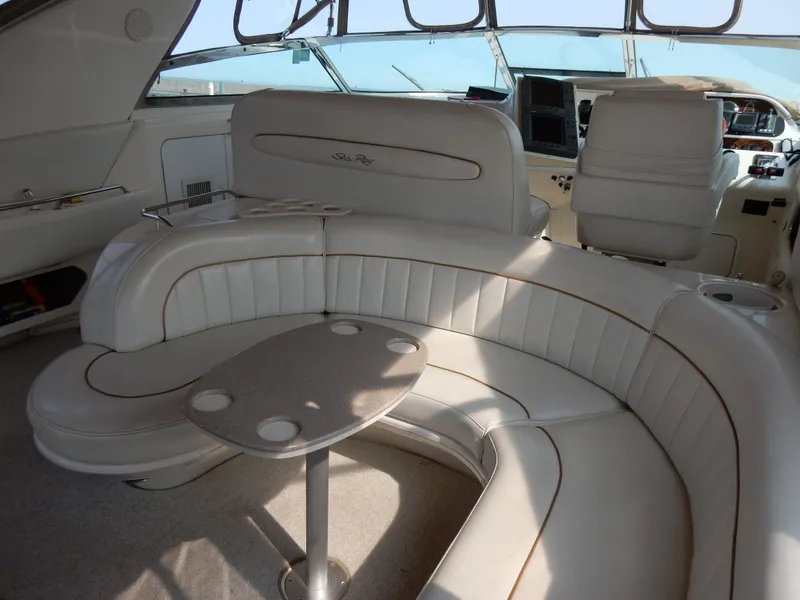 Slide: The Image of Luxurious interior of a 1997 Sea Ray 450 yacht with plush seating and table. - 10