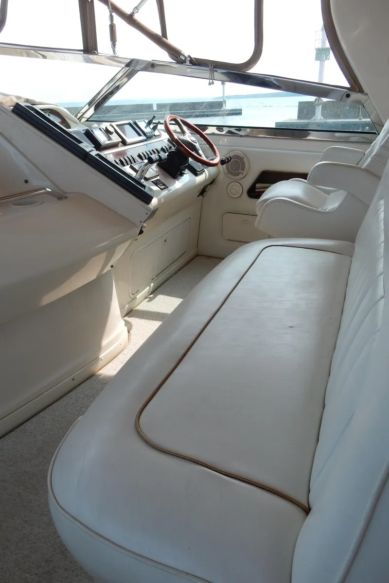 Slide: The Image of 1997 Sea Ray 450 yacht interior with white seating and control panel. - 11