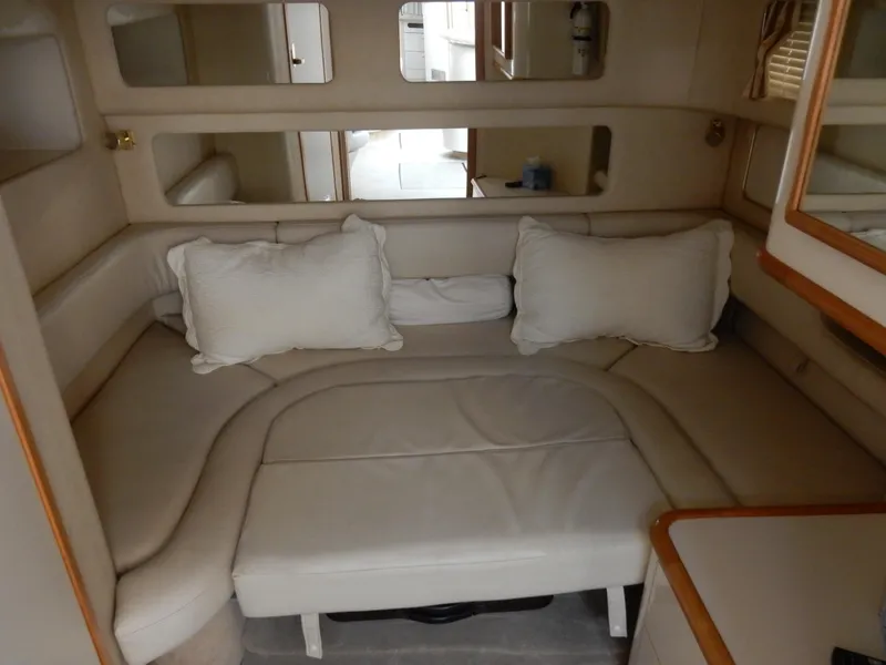 Slide: The Image of Interior of 1997 Sea Ray 450 yacht with beige seating and cushions. - 16