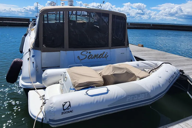 Slide: The Image of 1997 Sea Ray 450 yacht docked with Zodiac ProJet inflatable boat. - 2