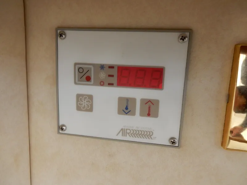 Slide: The Image of Control panel on a 1997 Sea Ray 450 boat, featuring digital display and buttons. - 21