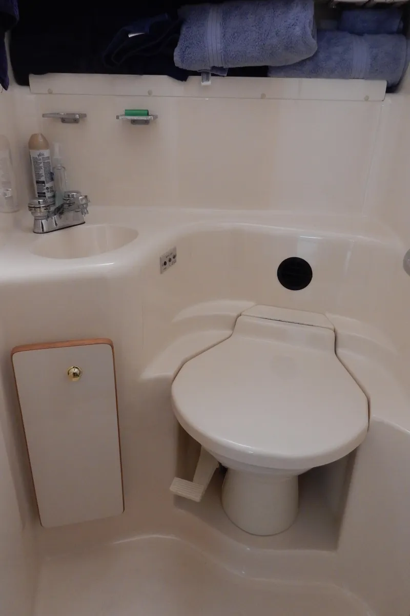 Slide: The Image of 1997 Sea Ray 450 yacht bathroom with sink and toilet. - 22
